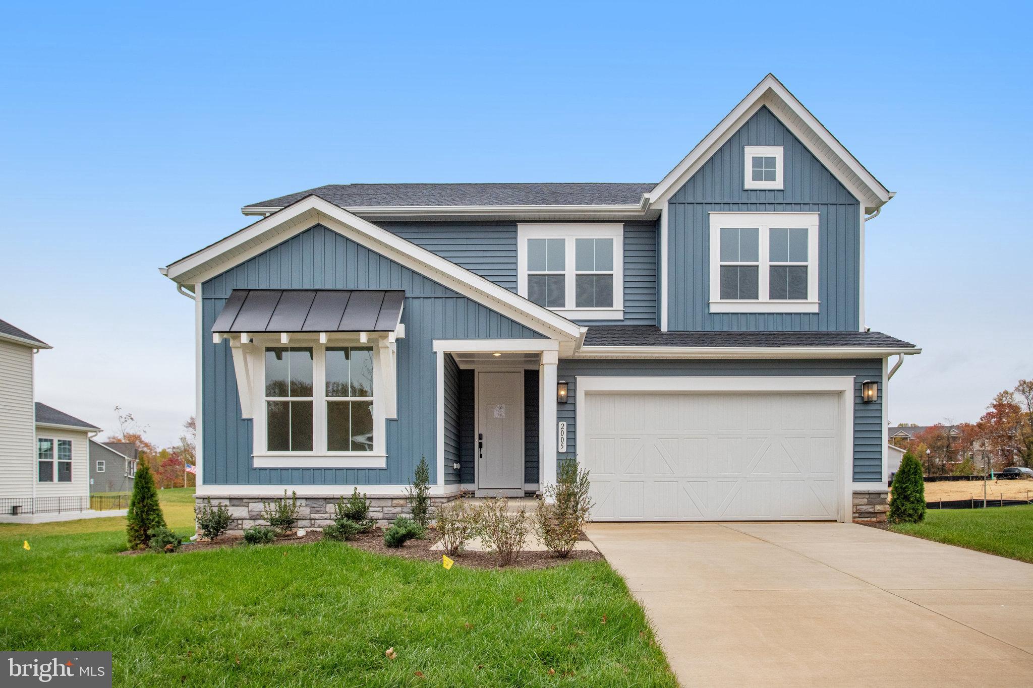 a front view of a house with a garden and yard