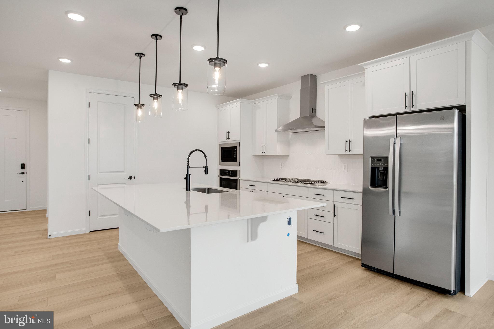 2005 Divot Drive Culpeper, VA 22701 - Photo 11 of 46 a kitchen with kitchen island white cabinets and stainless steel appliances