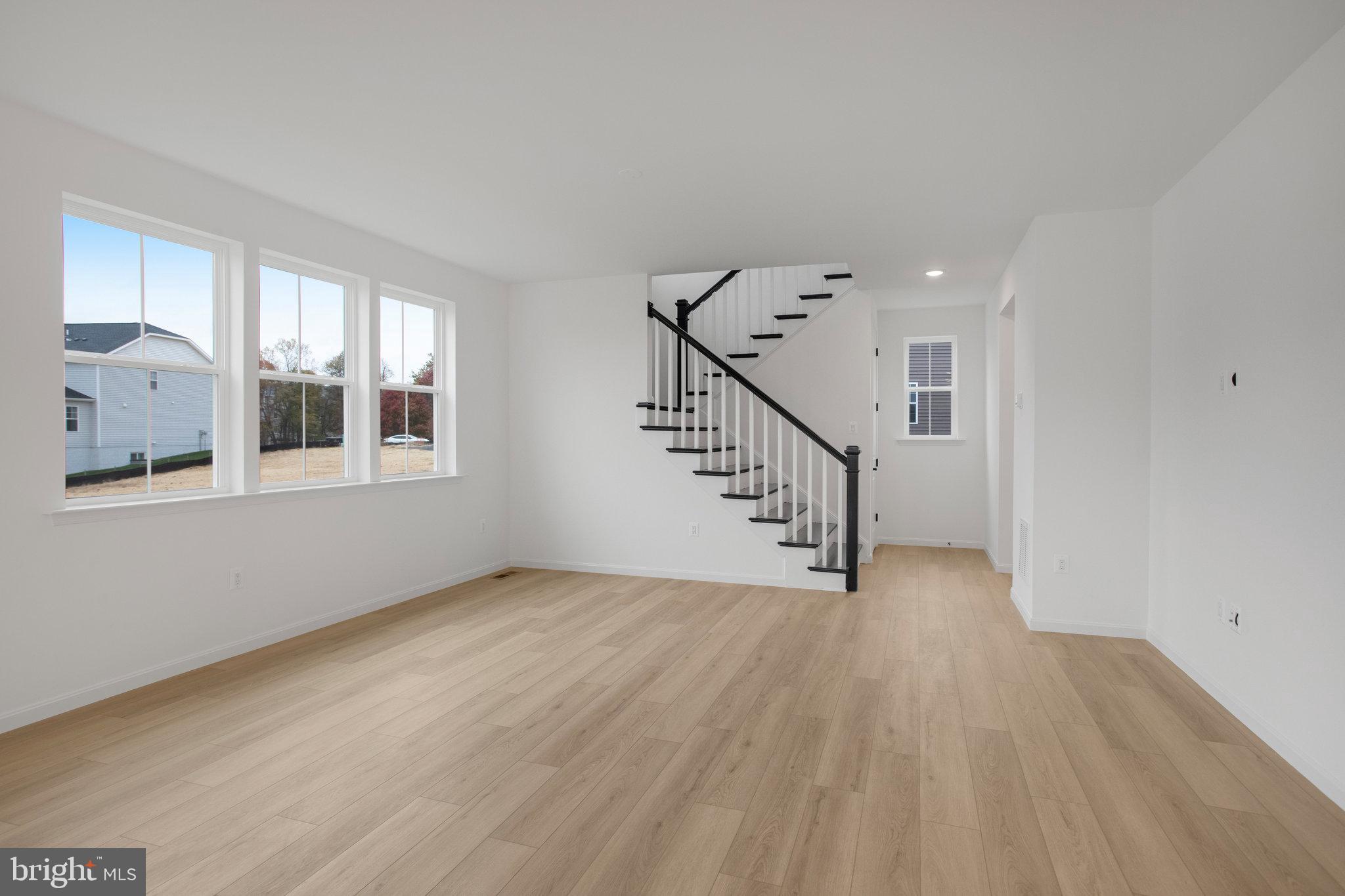 2005 Divot Drive Culpeper, VA 22701 - Photo 14 of 46 a view of an empty room with wooden floor and a window