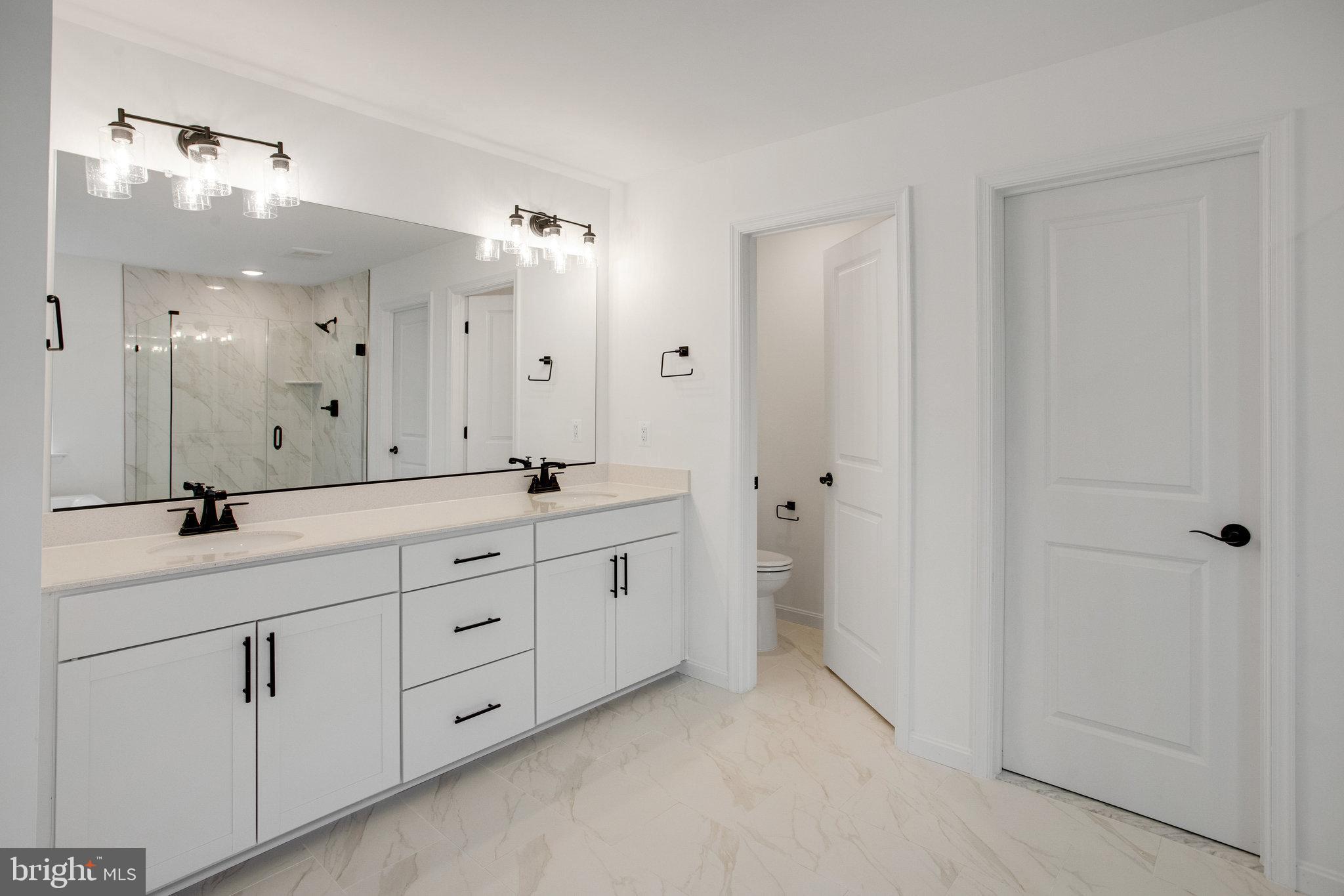 2005 Divot Drive Culpeper, VA 22701 - Photo 22 of 46 a spacious bathroom with a double vanity sink a mirror and a shower