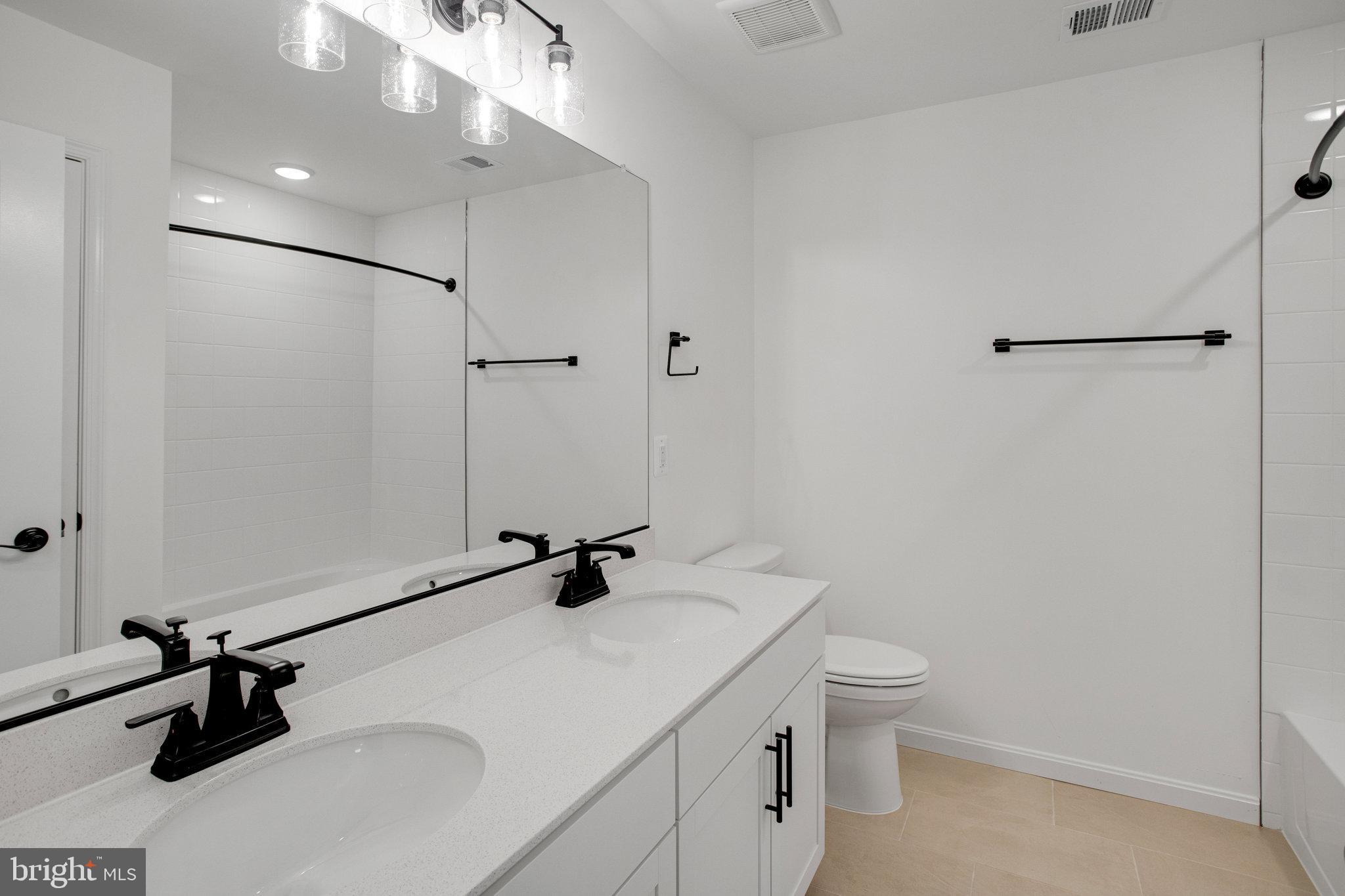 2005 Divot Drive Culpeper, VA 22701 - Photo 27 of 46 a bathroom with a sink a toilet and a tub