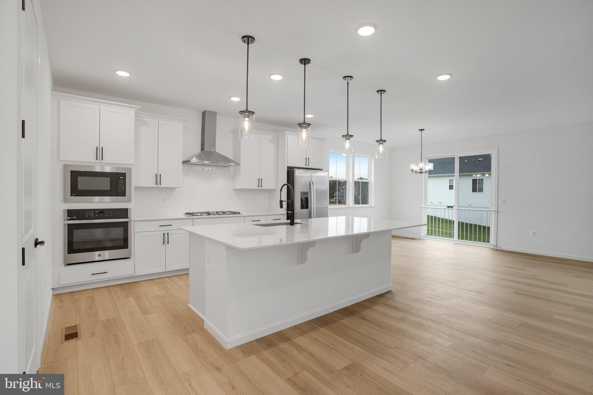 2005 Divot Drive Culpeper, VA 22701 - Photo 9 of 46 a large kitchen with stainless steel appliances kitchen island a large counter top and a sink