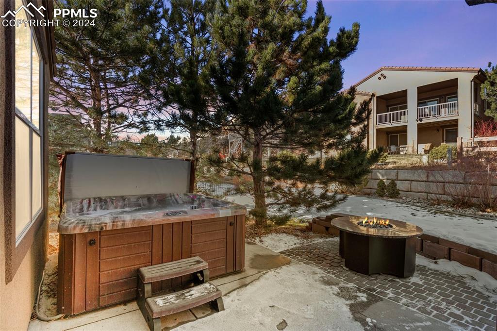 2464 Cinnabar Road Colorado Springs, CO 80921 - Photo 33 of 43 a view of a backyard with table and chairs potted plants and a large tree