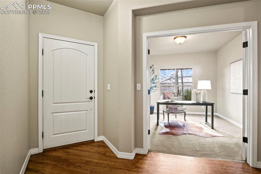 2464 Cinnabar Road Colorado Springs, CO 80921 - Photo 5 of 43 a view of a livingroom with furniture and wooden floor