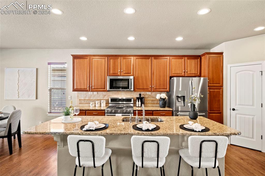 2464 Cinnabar Road Colorado Springs, CO 80921 - Photo 8 of 43 a dining room with stainless steel appliances granite countertop a table and chairs