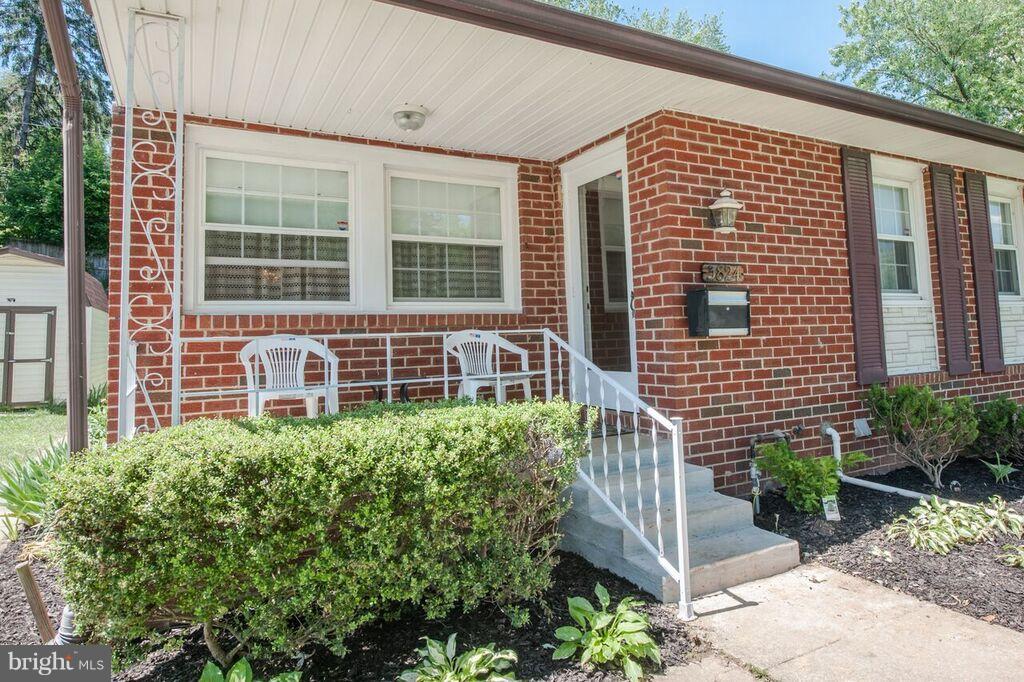3824 Offutt Road Randallstown, MD 21133 - Photo 1 of 27 a front view of a house with a yard and potted plants