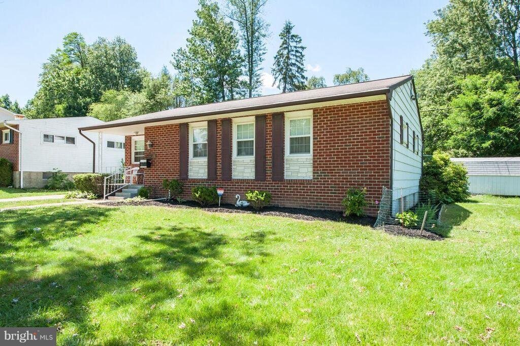 3824 Offutt Road Randallstown, MD 21133 - Photo 2 of 27 a front view of a house with yard and green space
