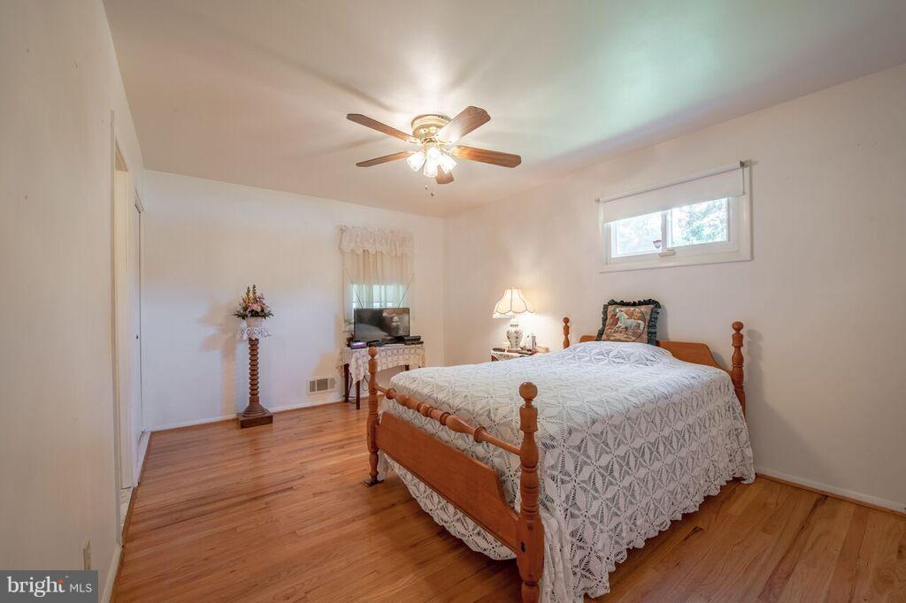 3824 Offutt Road Randallstown, MD 21133 - Photo 13 of 27 a bedroom with bed and a chandelier
