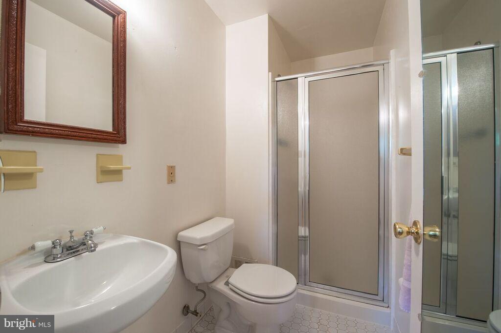 3824 Offutt Road Randallstown, MD 21133 - Photo 14 of 27 a white toilet sitting next to a bathroom sink