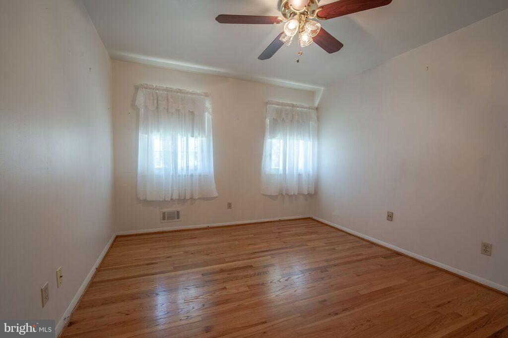 3824 Offutt Road Randallstown, MD 21133 - Photo 15 of 27 wooden floor in an empty room with a window