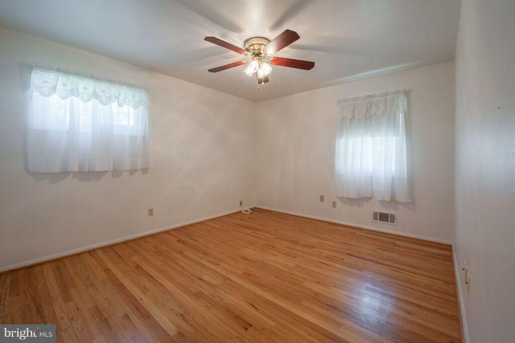 3824 Offutt Road Randallstown, MD 21133 - Photo 16 of 27 an empty room with windows and fan