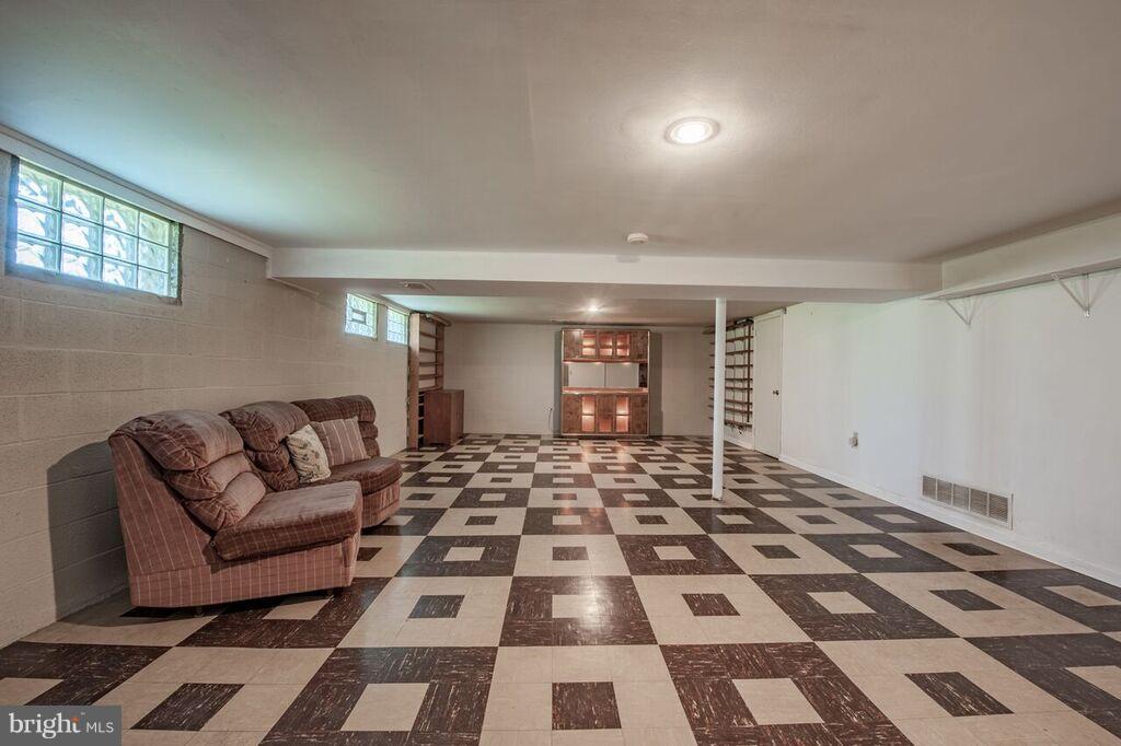 3824 Offutt Road Randallstown, MD 21133 - Photo 20 of 27 a living room with a black white checkered floor with couches and a coffee table