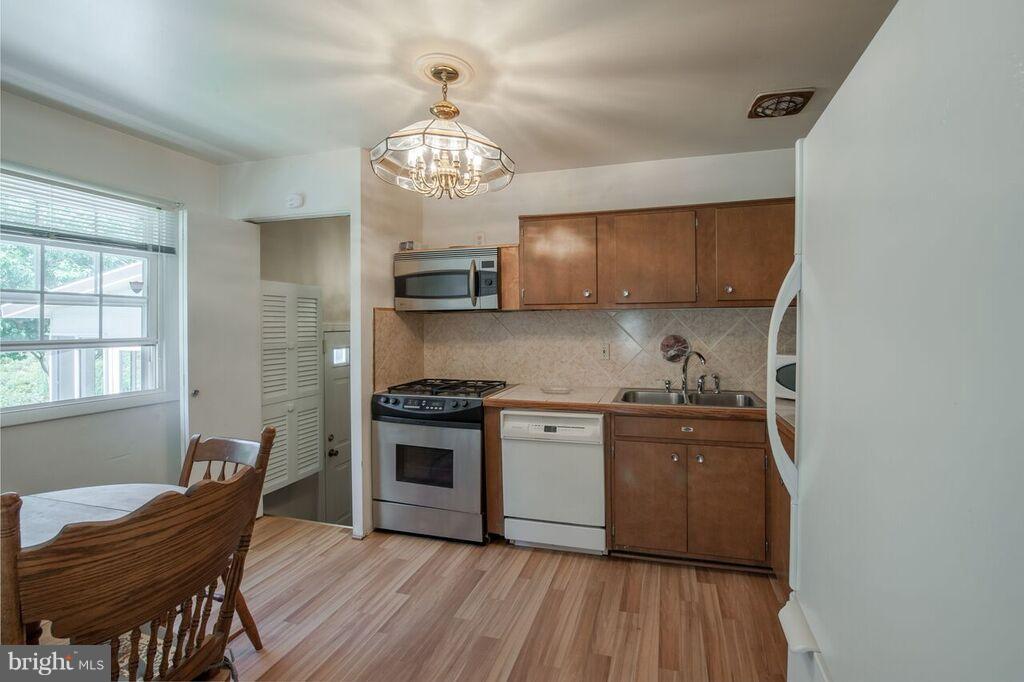 3824 Offutt Road Randallstown, MD 21133 - Photo 6 of 27 a kitchen with stainless steel appliances granite countertop a stove and a refrigerator