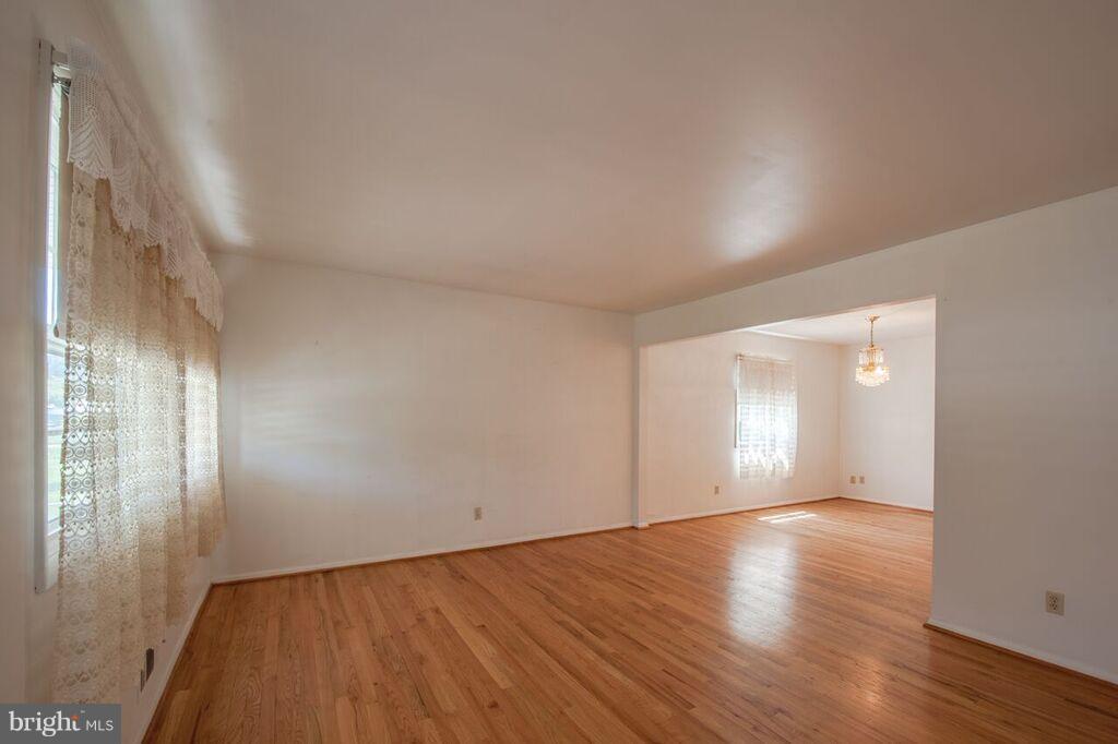 3824 Offutt Road Randallstown, MD 21133 - Photo 9 of 27 a view of an empty room with wooden floor and a window