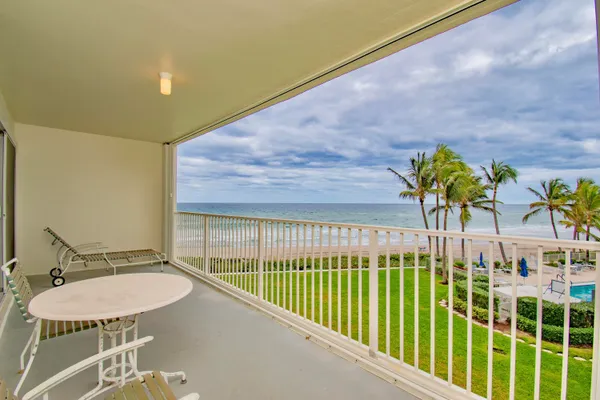 a view of a balcony and dining area
