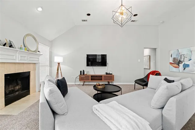 a living room with furniture a fireplace and a flat screen tv