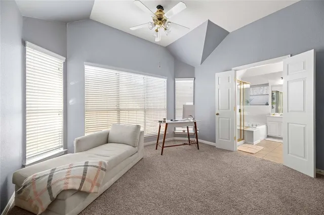 a spacious bedroom with a bed and a chandelier