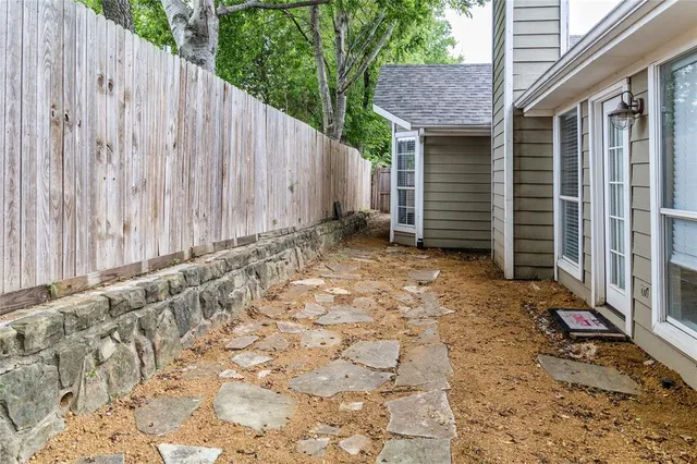 a backyard of a house with a large tree