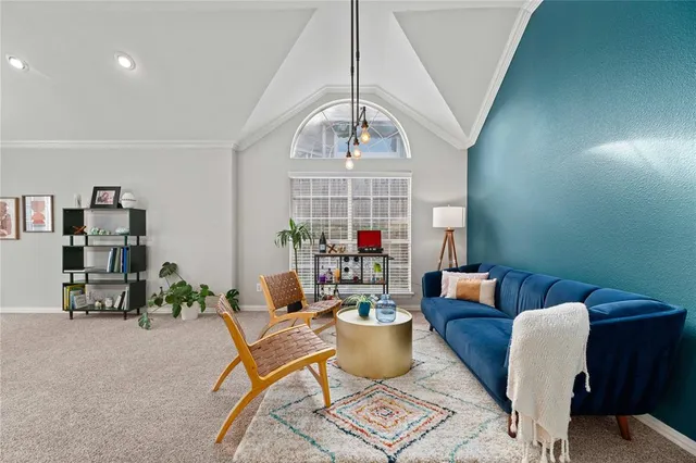 a dining room with furniture a rug and a chandelier
