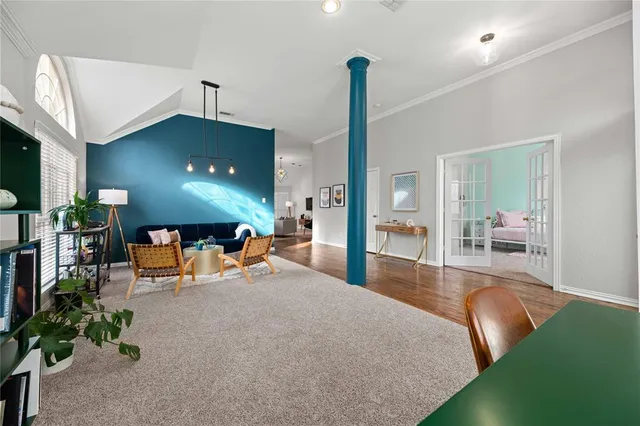 a living room with furniture and a chandelier