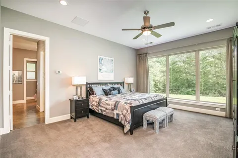 a bedroom with a bed dresser and a window