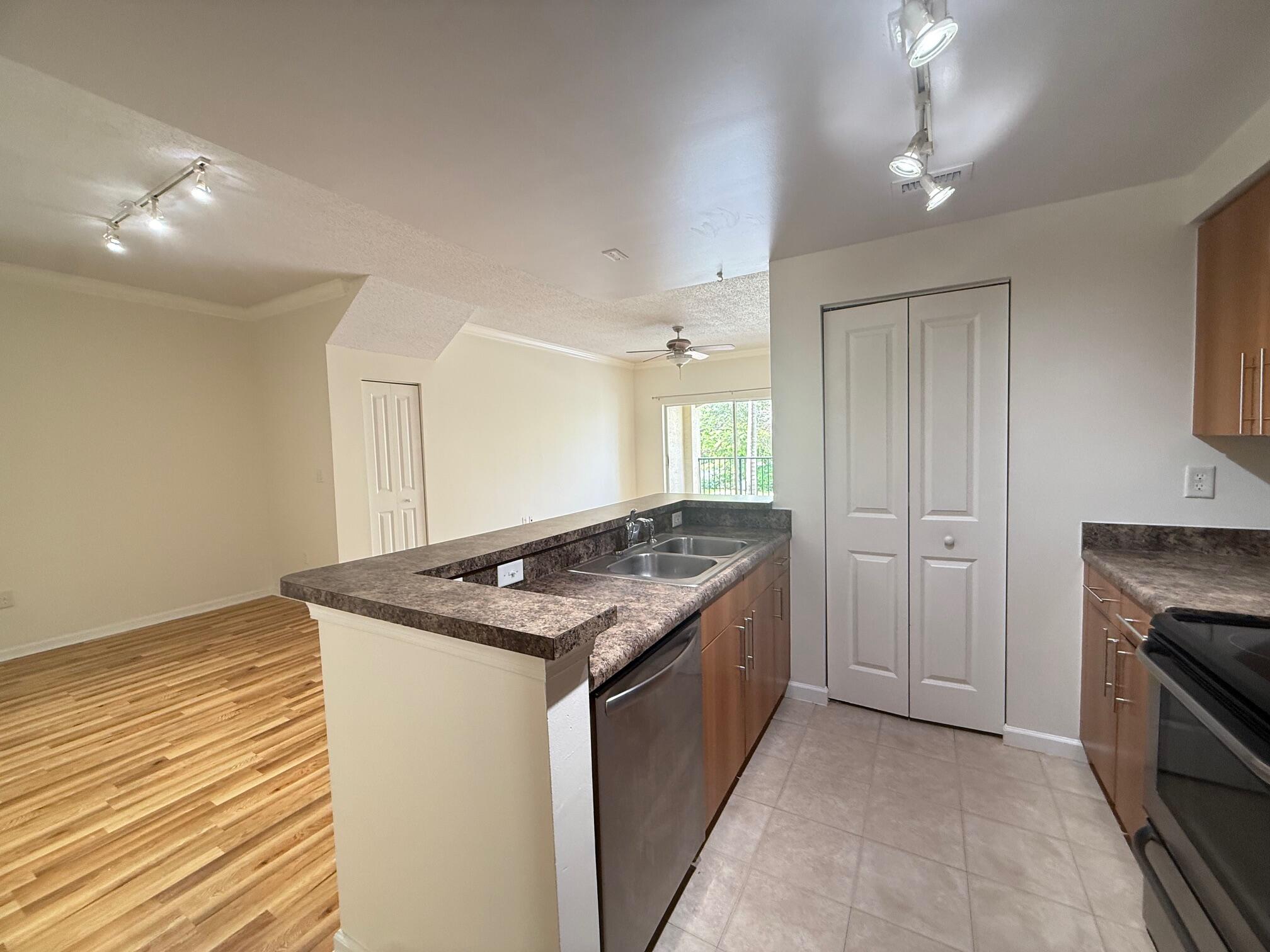 5800 West Sample Road, Unit 207 Coral Springs, FL 33067 - Photo 4 of 22 a kitchen with a stove and a sink