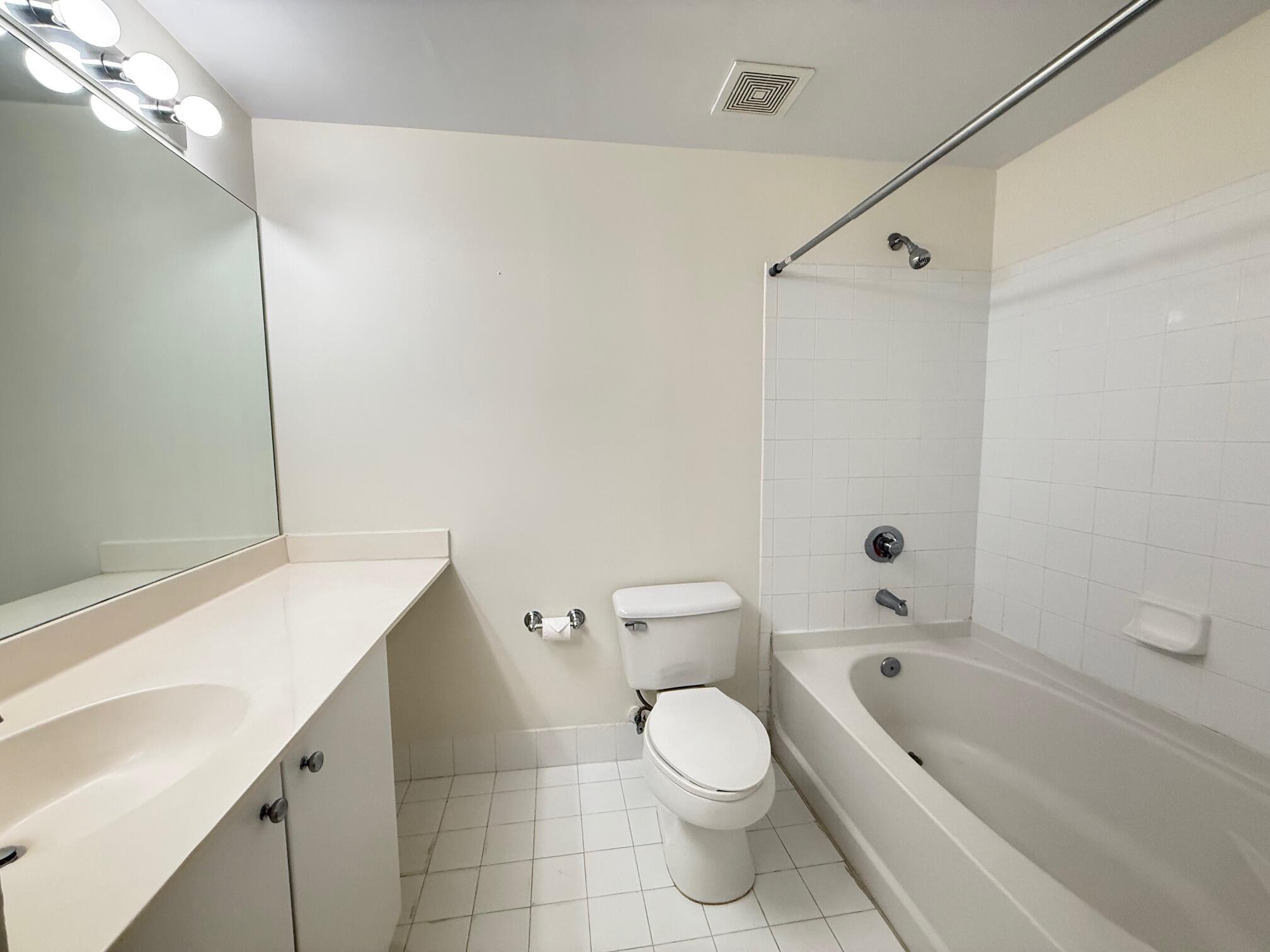5800 West Sample Road, Unit 207 Coral Springs, FL 33067 - Photo 6 of 22 a bathroom with a sink a toilet and shower