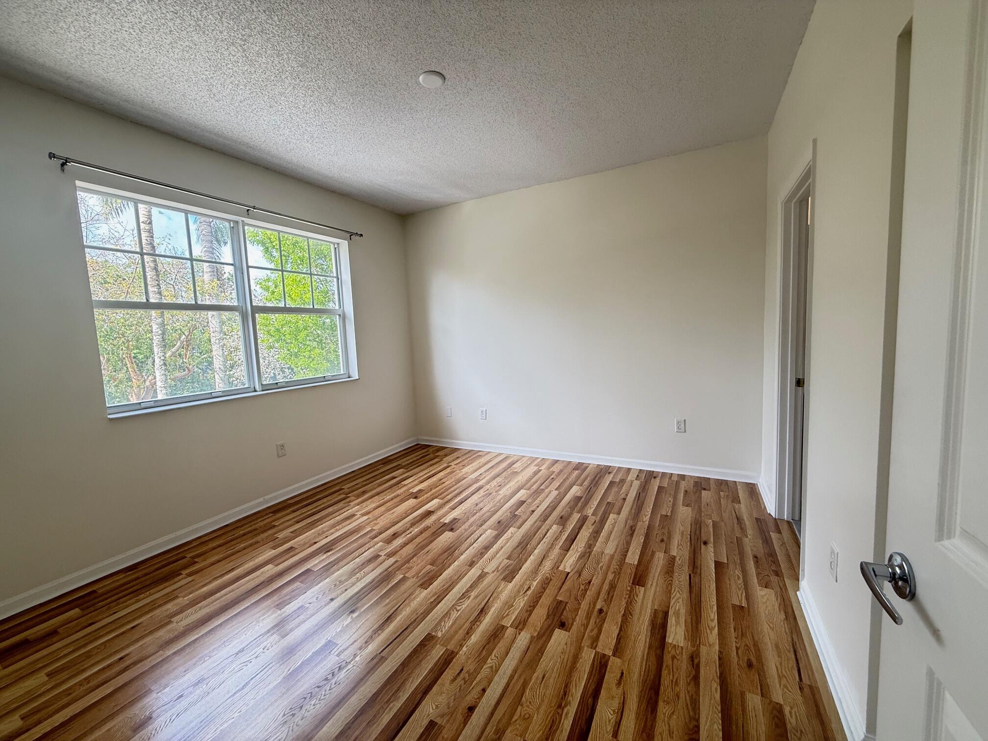 5800 West Sample Road, Unit 207 Coral Springs, FL 33067 - Photo 9 of 22 a view of a room with wooden floor and window