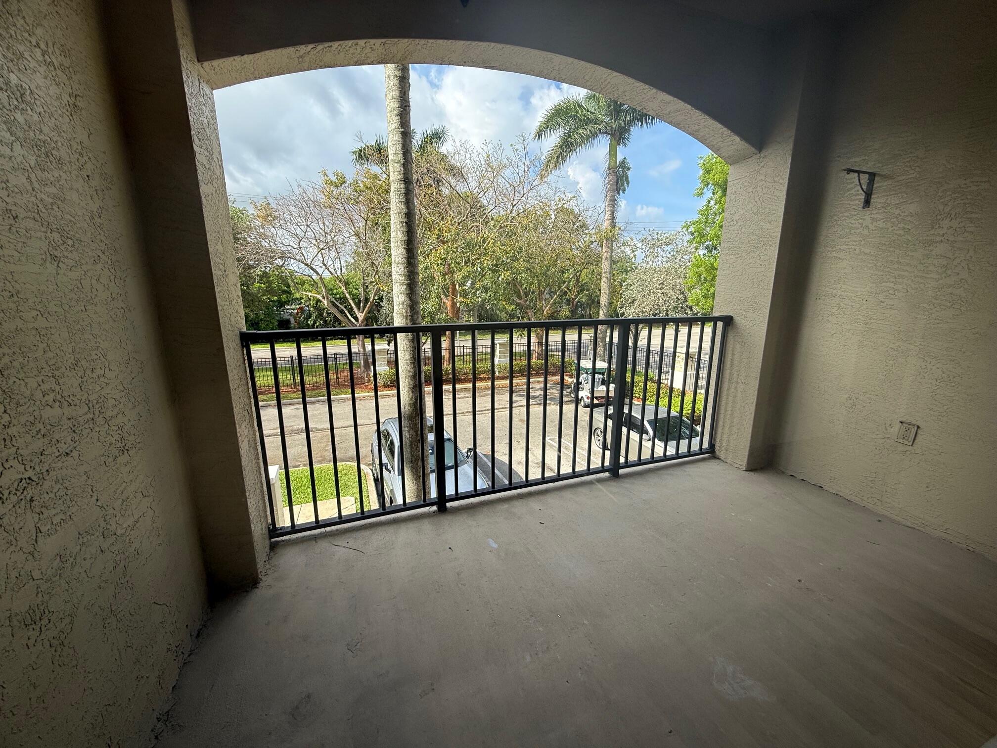 5800 West Sample Road, Unit 207 Coral Springs, FL 33067 - Photo 10 of 22 a view of a glass door with a balcony from a window