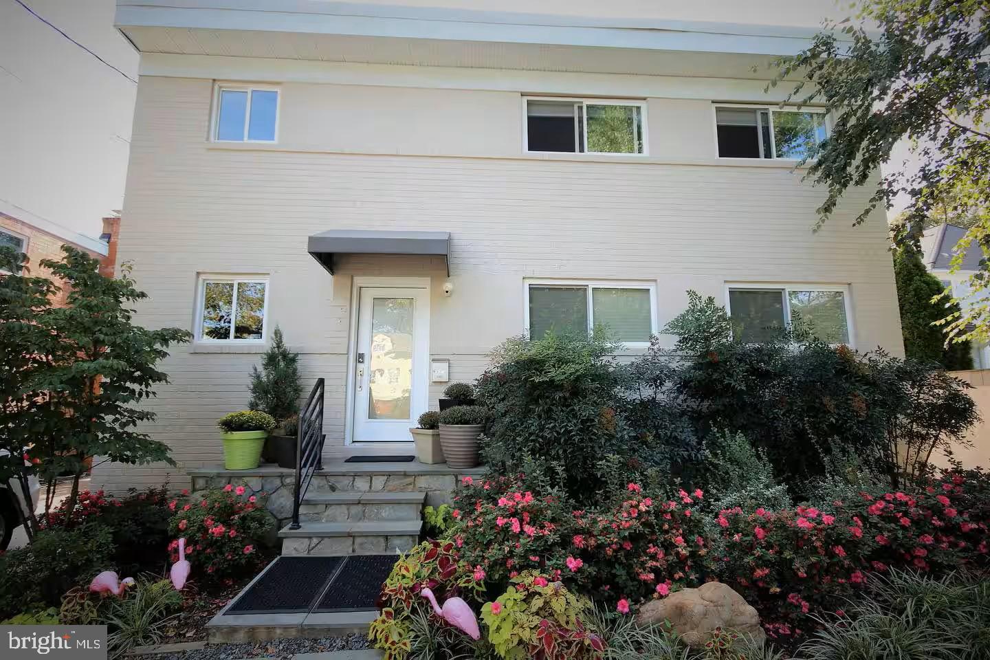 4118 18th Road North Arlington, VA 22207 - Photo 2 of 48 a front view of a house with a yard and garden