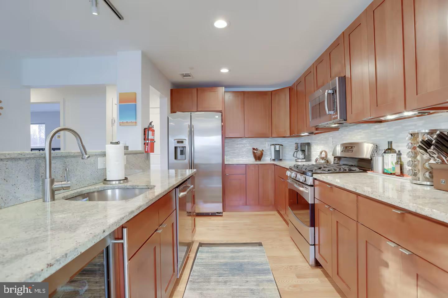 4118 18th Road North Arlington, VA 22207 - Photo 27 of 48 a kitchen with stainless steel appliances granite countertop a sink a stove and a refrigerator