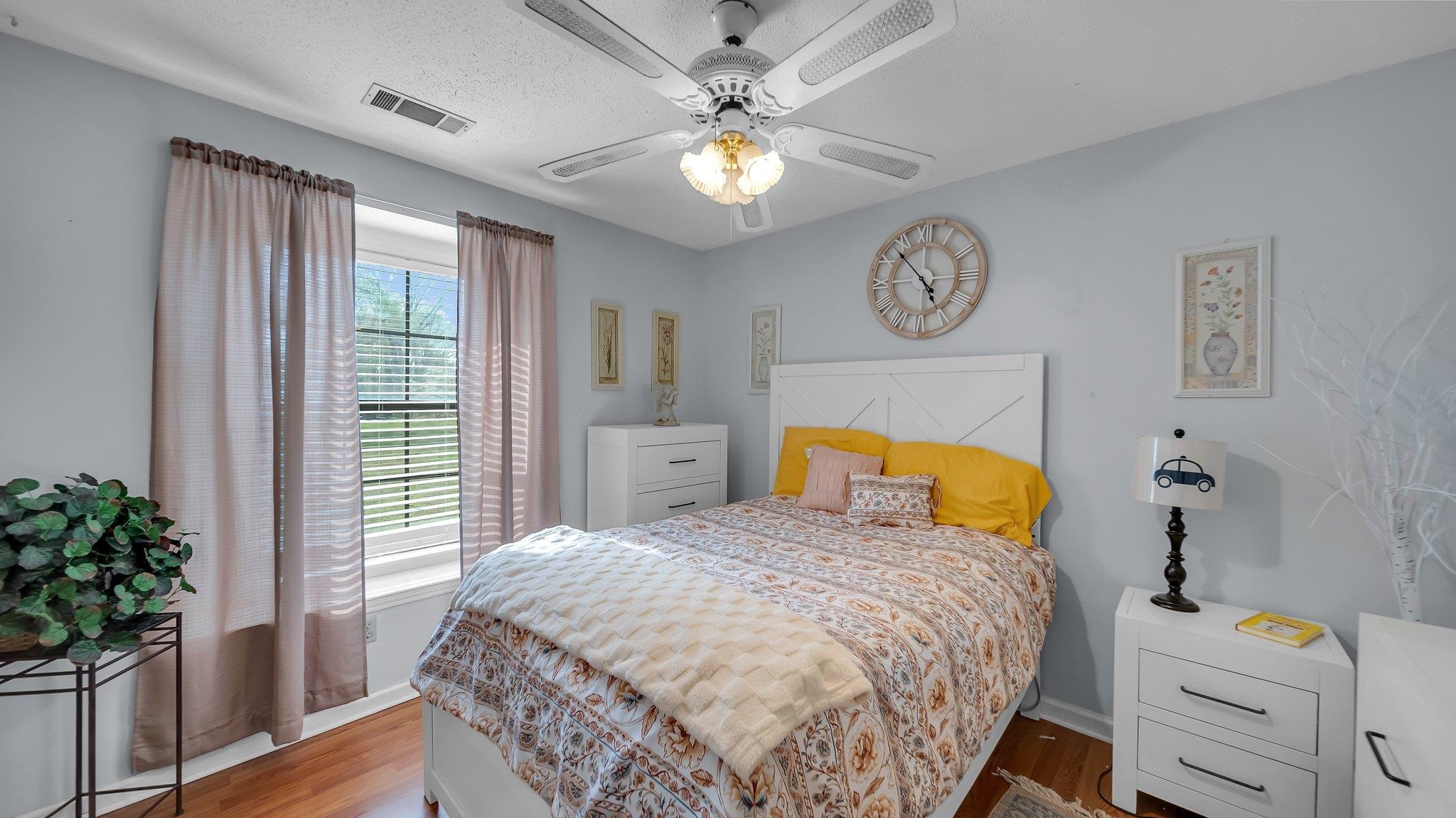 6488 Chase Road Millington, TN 38053 - Photo 15 of 22 Bedroom featuring wood finished floors, baseboards, ceiling fan, and visible vents