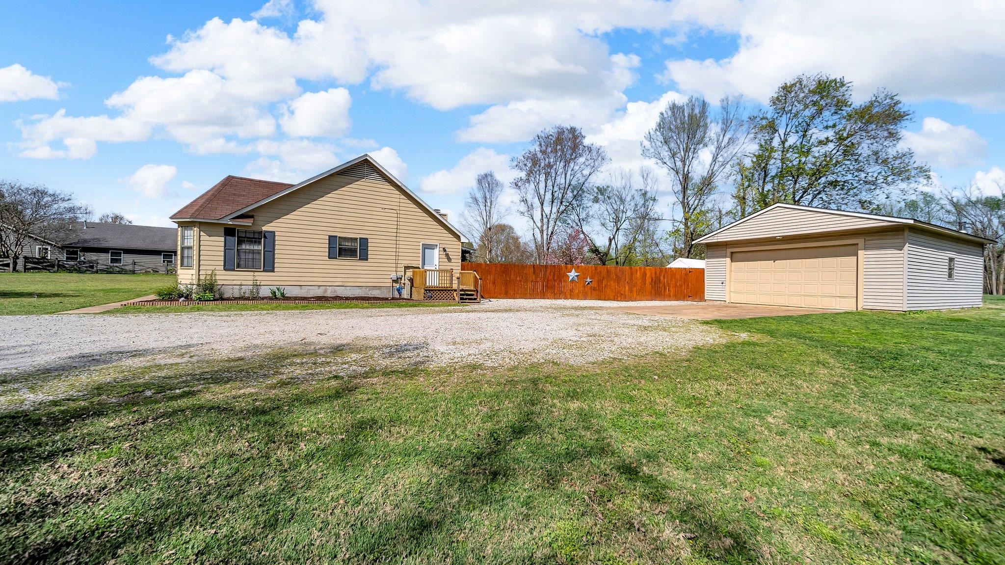 6488 Chase Road Millington, TN 38053 - Photo 3 of 22 View of side of property featuring an outdoor structure, fence, a garage, and a yard