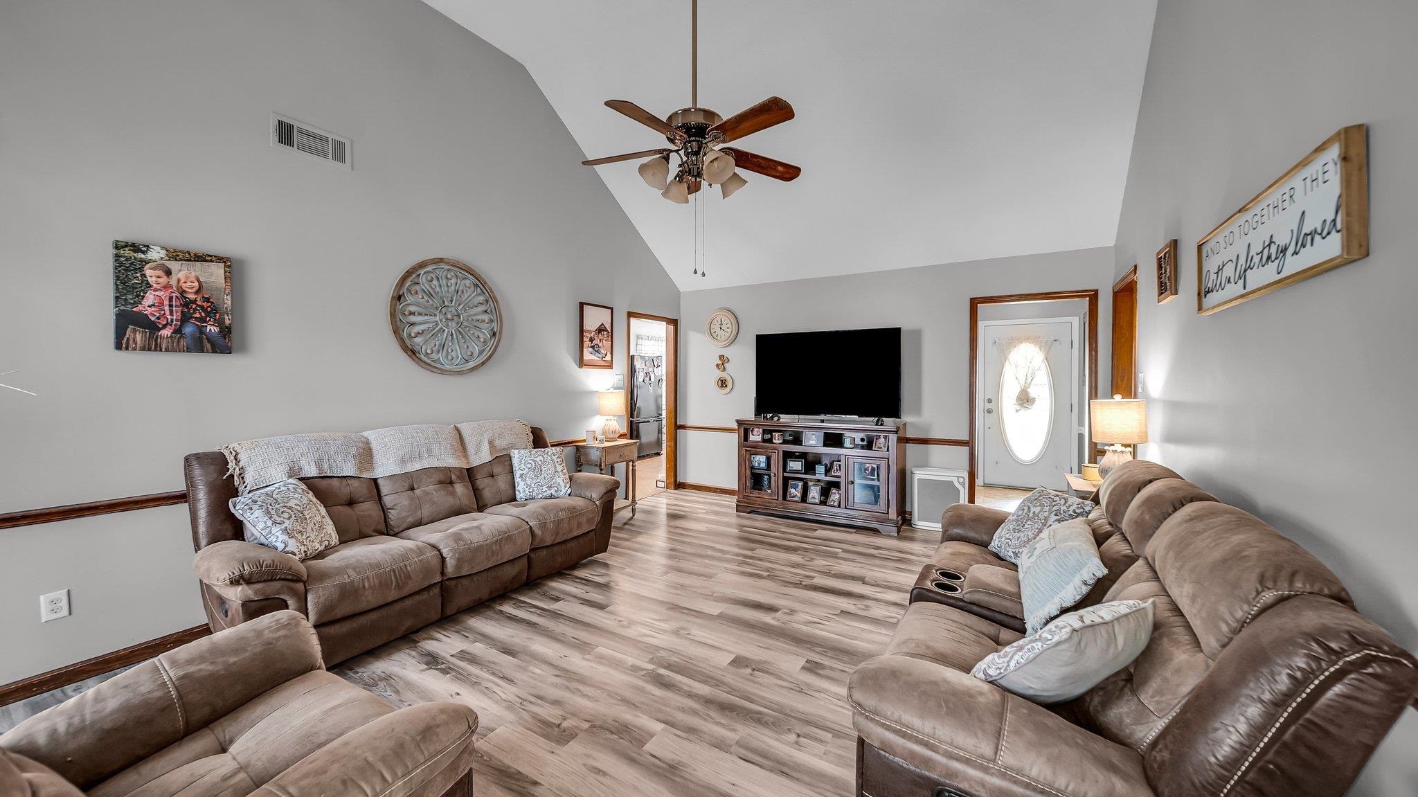 6488 Chase Road Millington, TN 38053 - Photo 8 of 22 Living area featuring high vaulted ceiling, a ceiling fan, light wood-type flooring, baseboards, and visible vents
