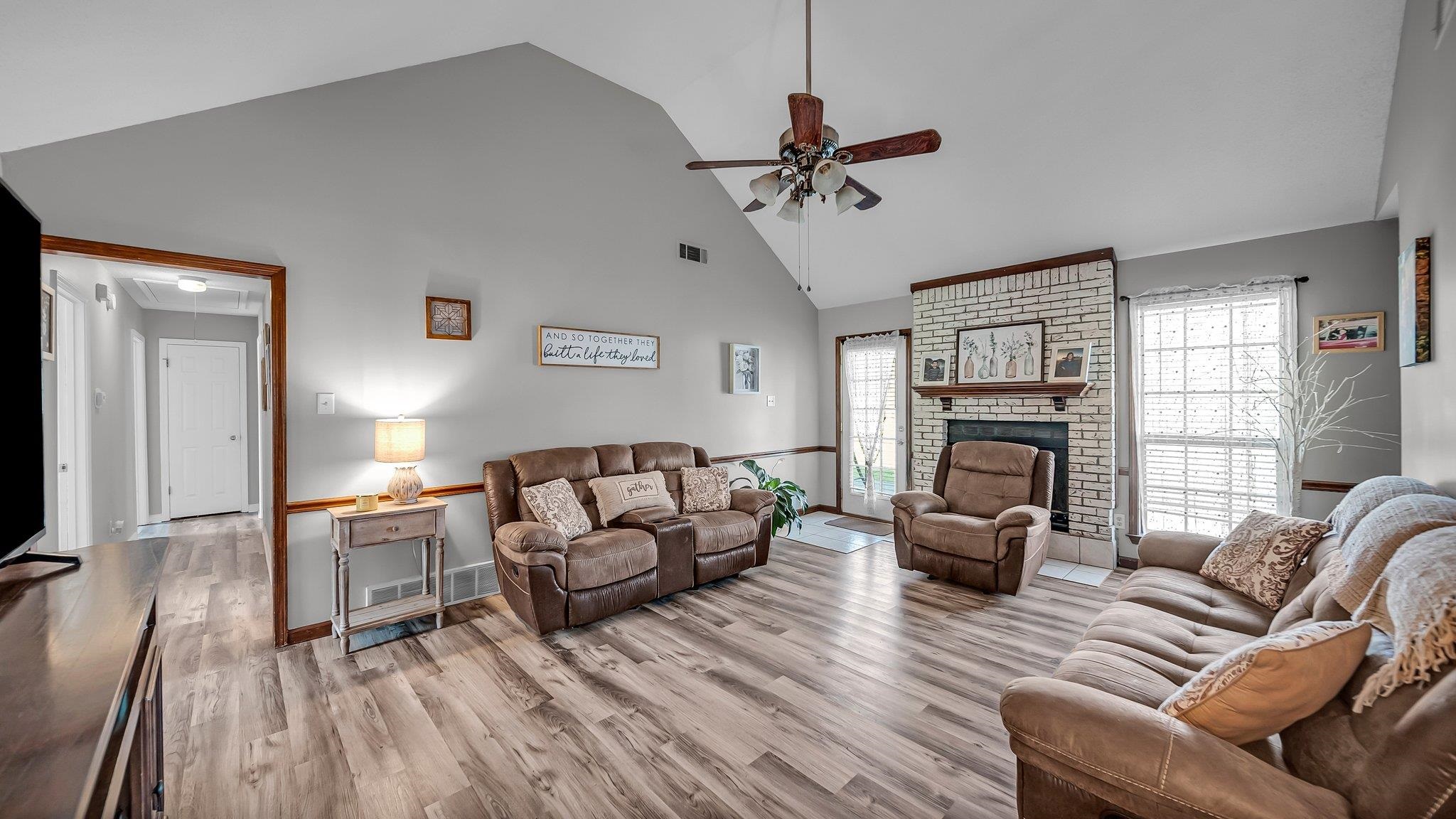 6488 Chase Road Millington, TN 38053 - Photo 9 of 22 Living area with wood finished floors, high vaulted ceiling, a healthy amount of sunlight, and ceiling fan