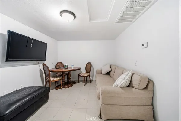 a bedroom with furniture and a flat screen tv