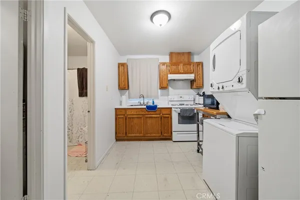 a utility room with cabinets washer and dryer