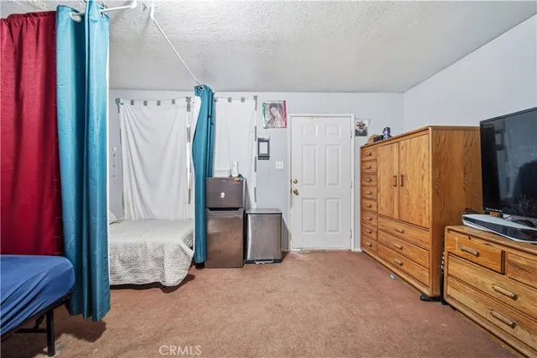 a bedroom with furniture and a flat tv screen
