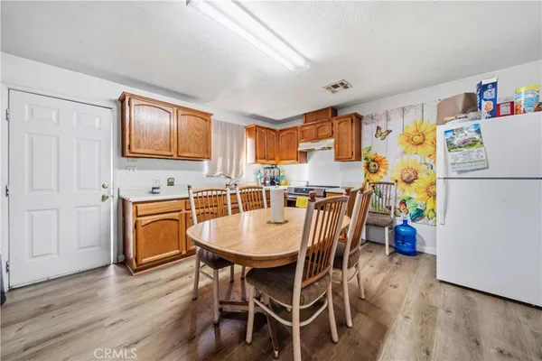 a dining room with a wooden table and chairs