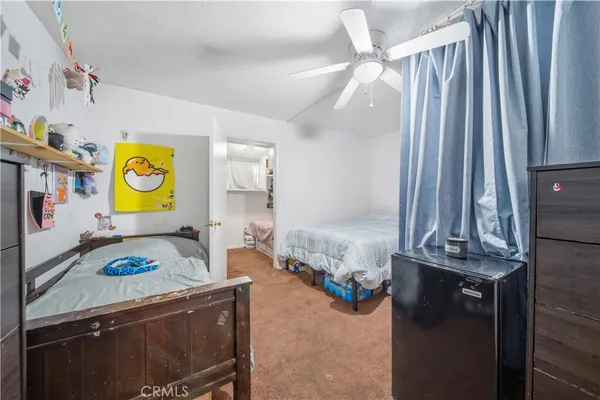a living room with a couch and a dresser next to a window