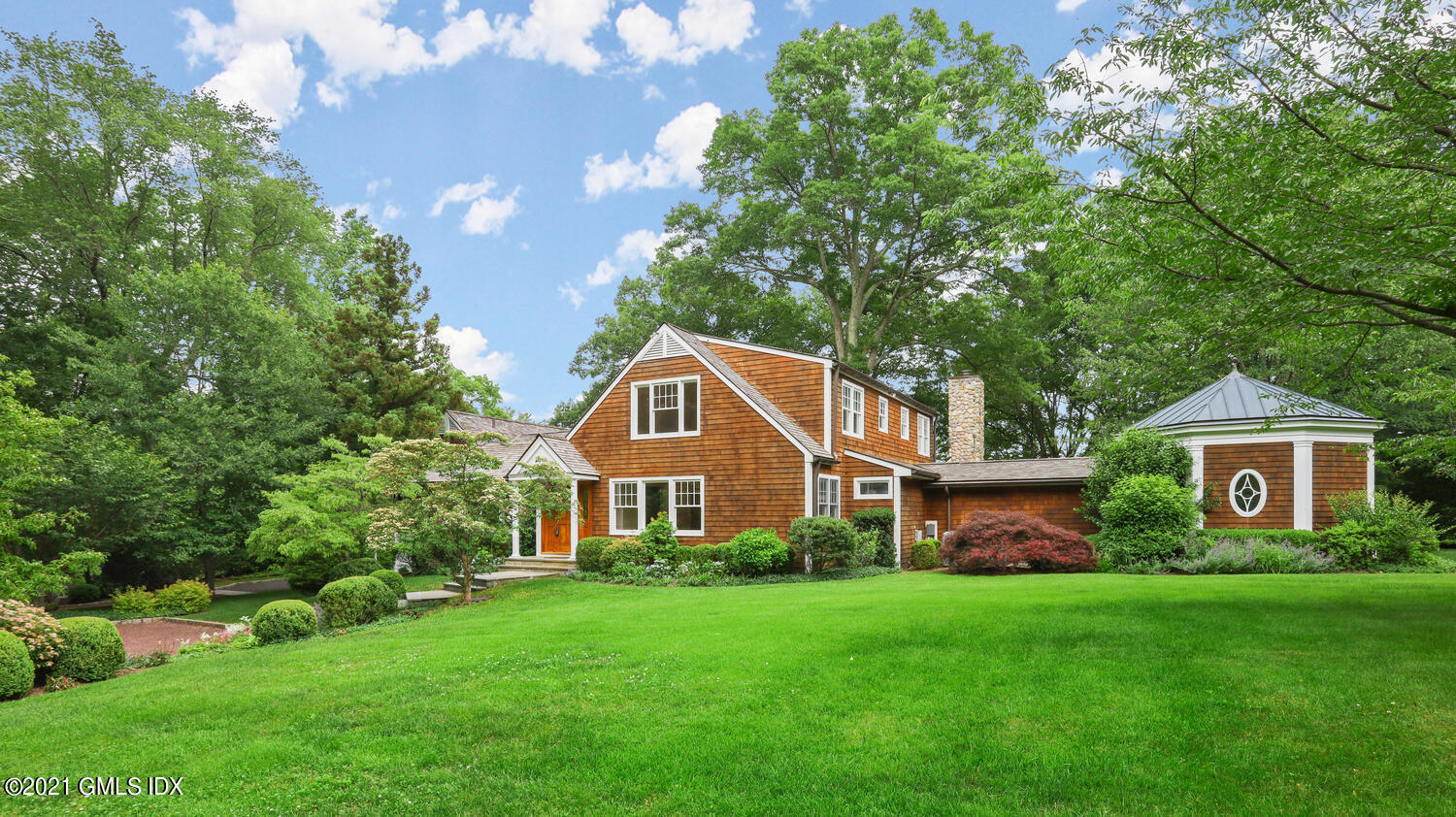66 Butternut Hollow Road Greenwich, CT 06830 - Photo 3 of 19 a front view of a house with a yard