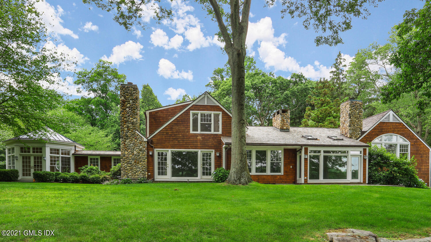 66 Butternut Hollow Road Greenwich, CT 06830 - Photo 5 of 19 a front view of a house with a garden