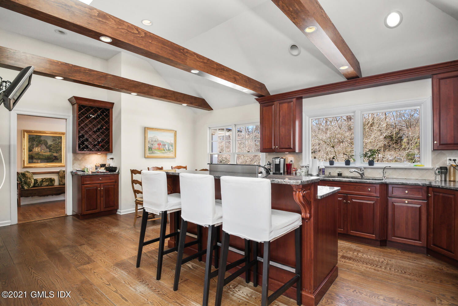 66 Butternut Hollow Road Greenwich, CT 06830 - Photo 8 of 19 a dining hall with stainless steel appliances granite countertop a stove a sink dishwasher a dining table and chairs with wooden floor
