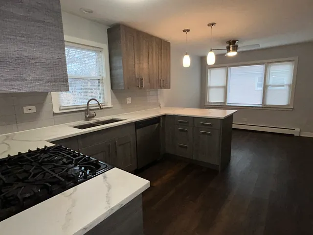 a kitchen with sink stove and cabinets