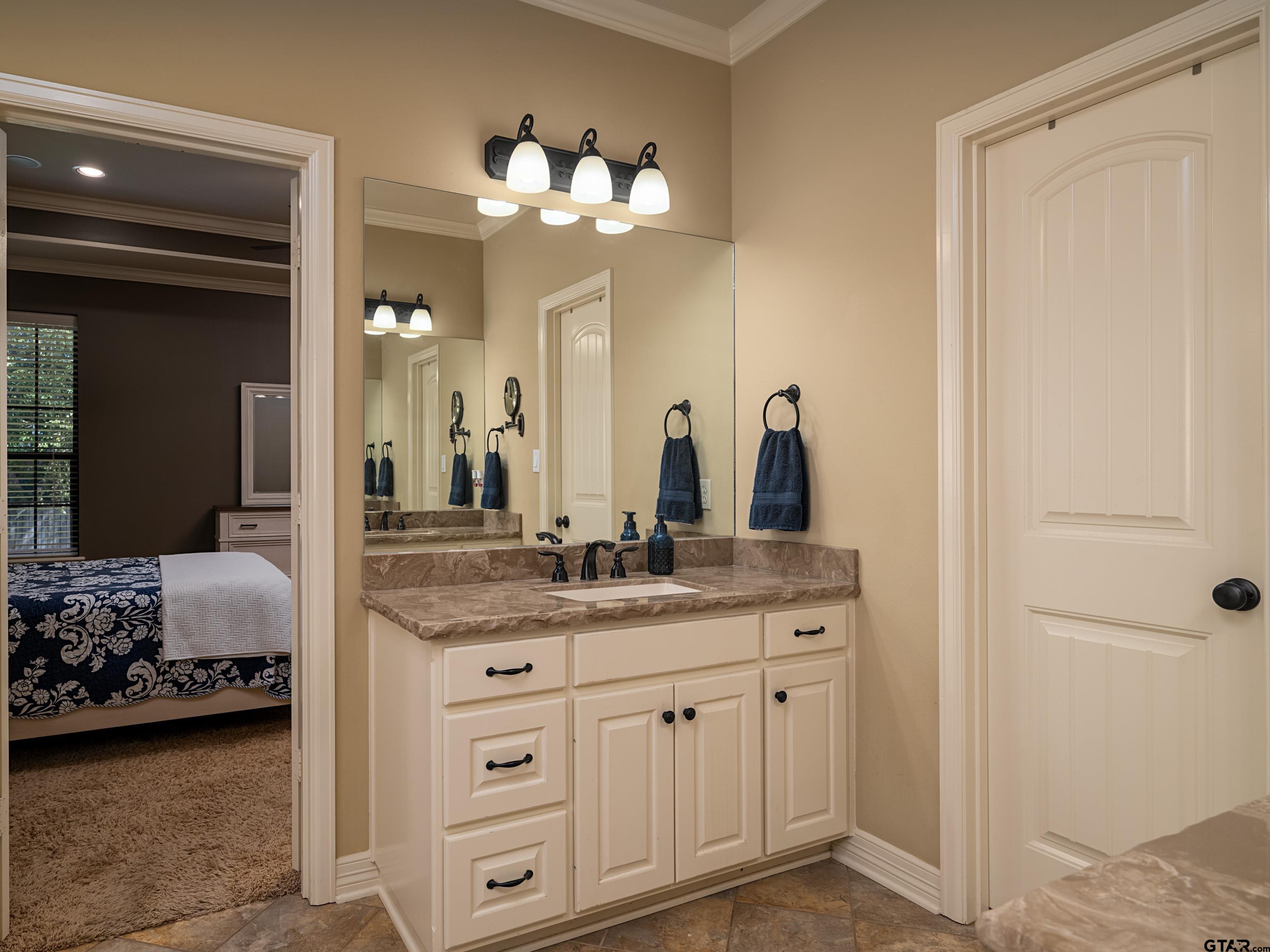 19560 Sandhill Lane Flint, TX 75762 - Photo 18 of 35 a spacious bathroom with a granite countertop sink and a mirror
