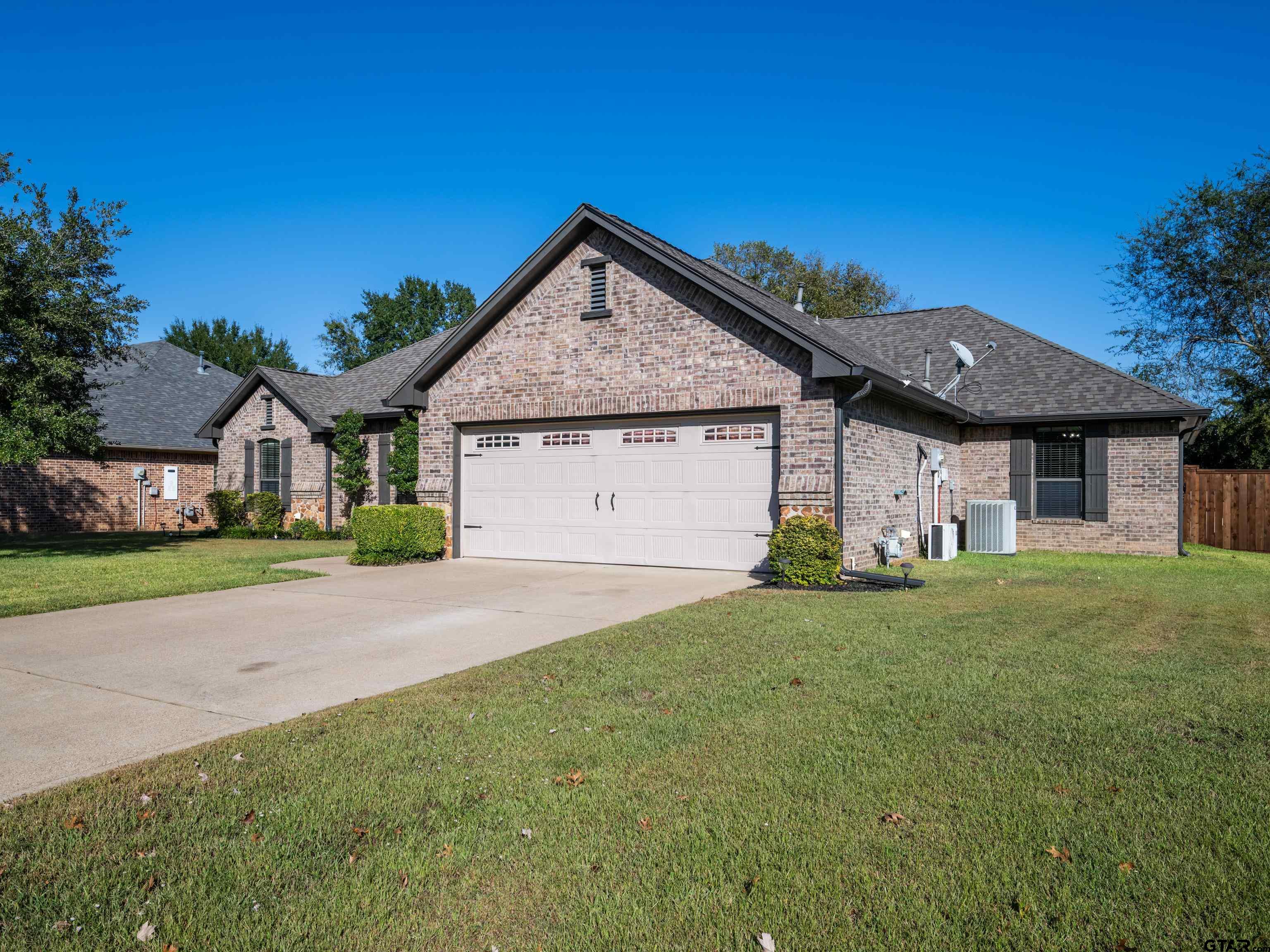 19560 Sandhill Lane Flint, TX 75762 - Photo 2 of 35 a front view of a house with a yard and garage