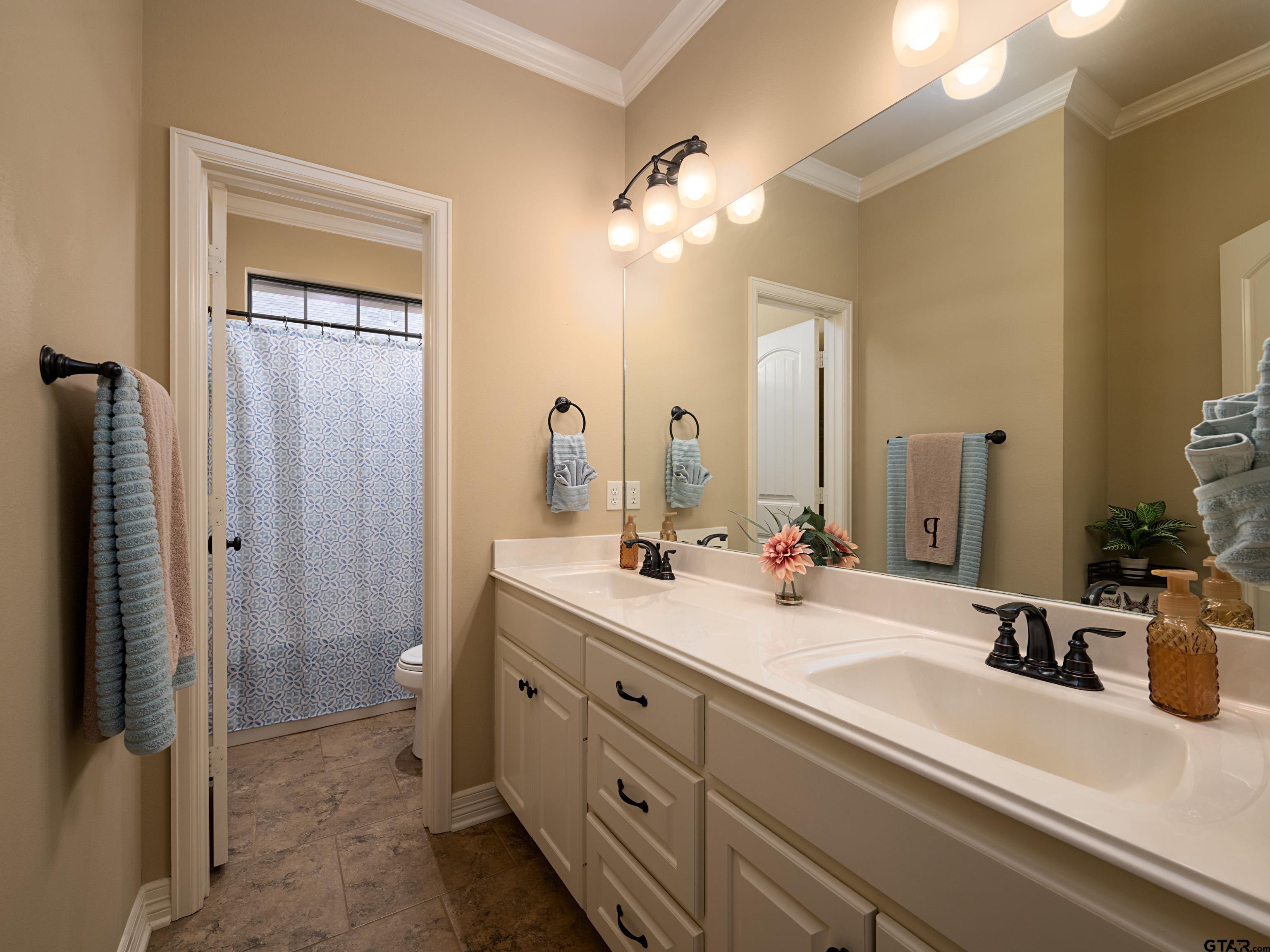 19560 Sandhill Lane Flint, TX 75762 - Photo 28 of 35 a bathroom with a double vanity sink mirror and shower