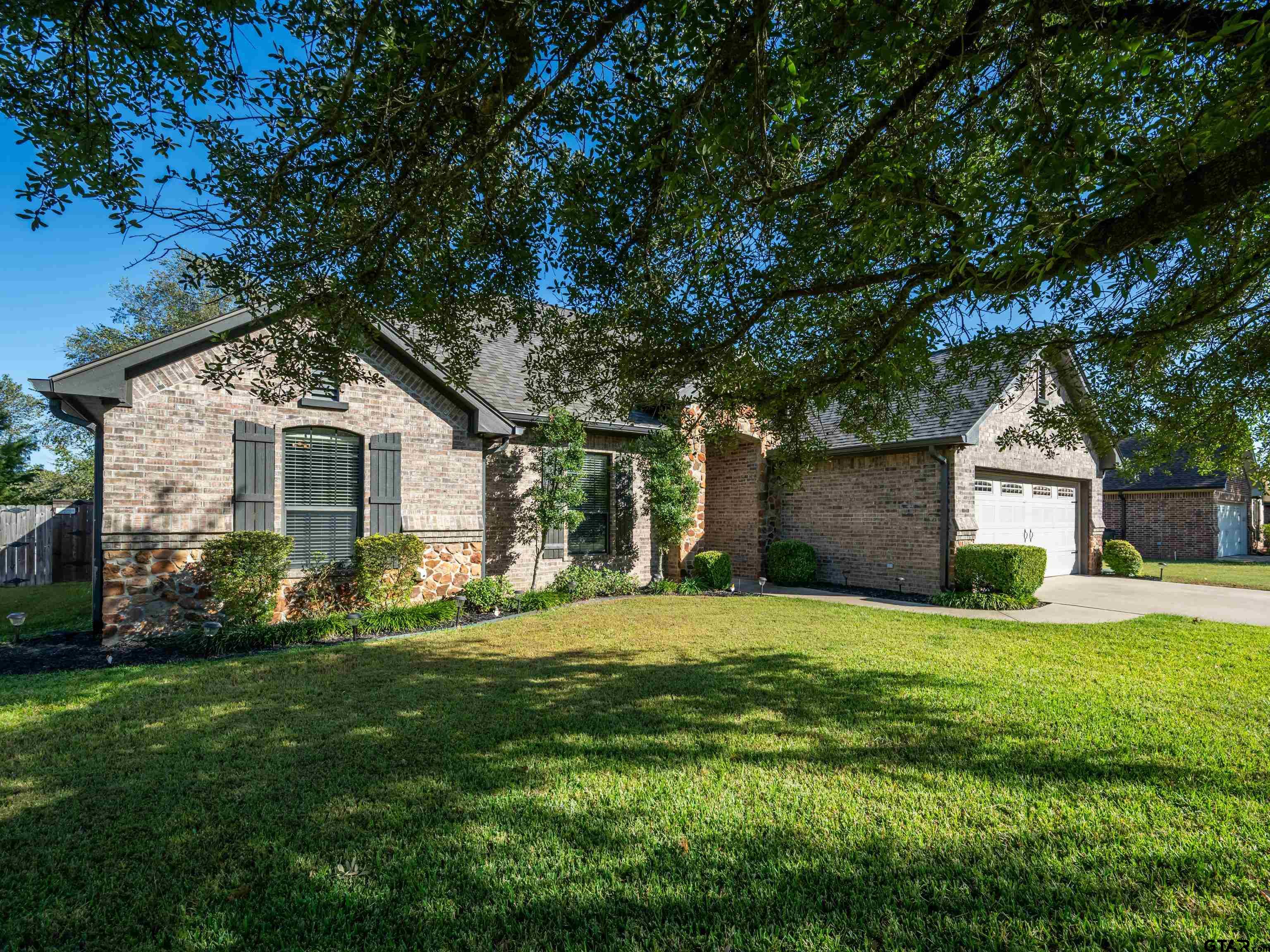 19560 Sandhill Lane Flint, TX 75762 - Photo 4 of 35 a front view of a house with a yard and garage