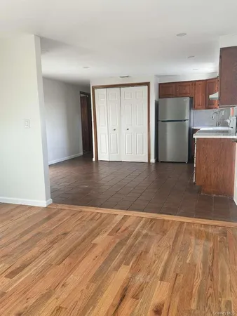 a view of a kitchen with a sink and a refrigerator