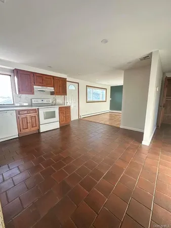 a kitchen with stainless steel appliances a sink a stove a microwave a counter top space and cabinets